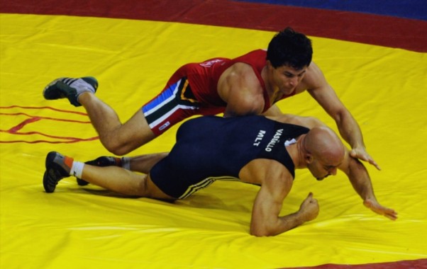 South Africa's Gerald Meyer in action againts A Vassallo of Malta in the wrestling freestyle competition 